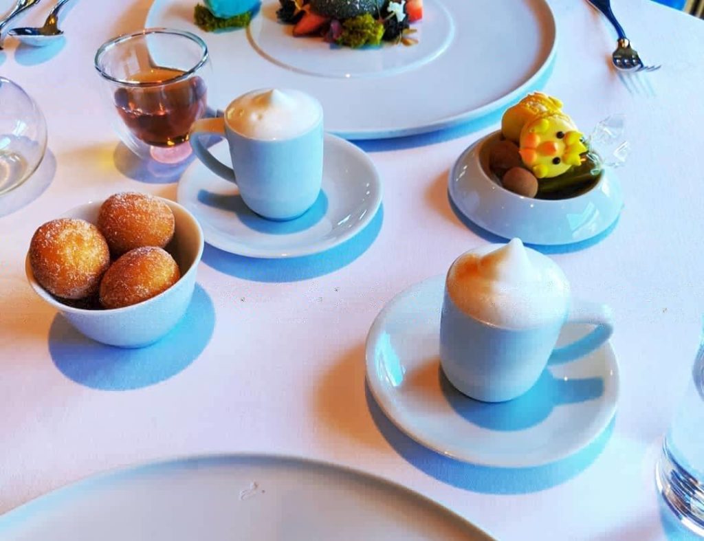 table with lattes, beignets, macarons